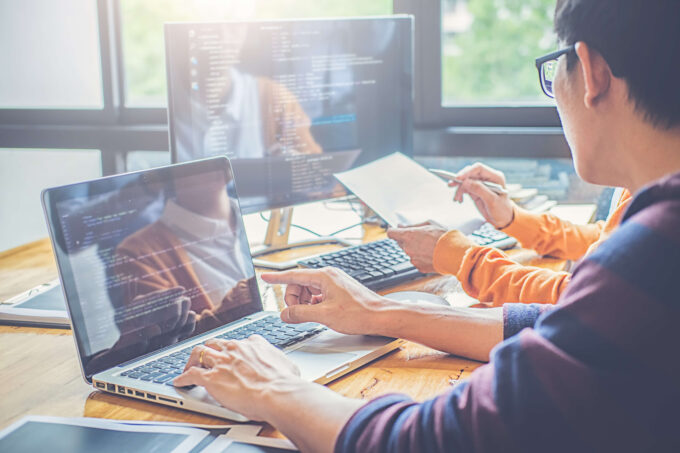 Close up shot of Java backend development team working on computers