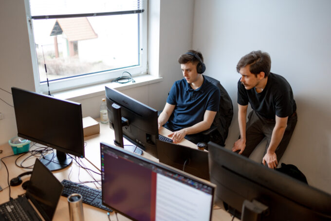Two man computer vision specialists looking at computer screen