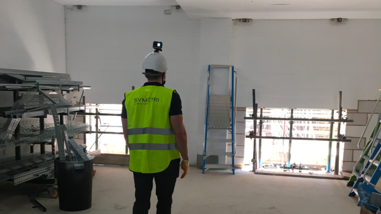Worker collecting construction site photos for automated documenting for AI algorithm