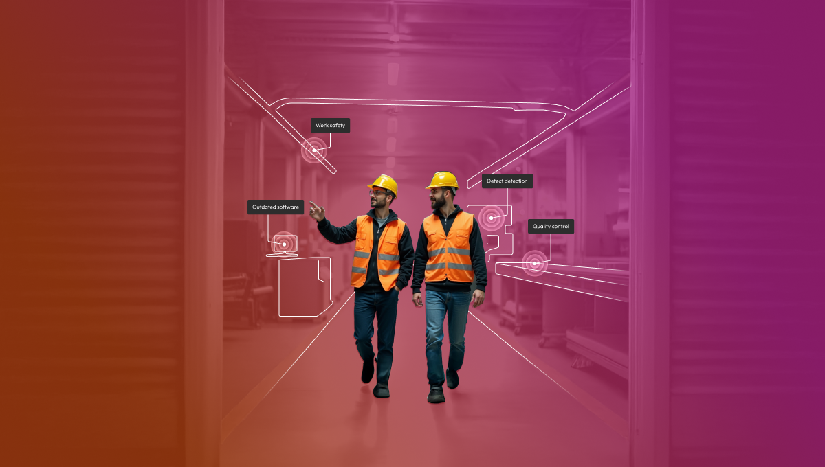 Two male workers in orange high-visibility vests and yellow hard hats walking through a warehouse corridor, surrounded by floating AI detection labels including work safety, defect detection, quality control, and connected devices, set against a red-to-purple gradient background